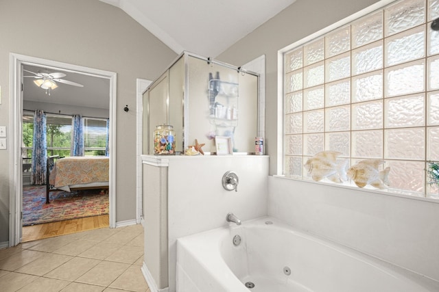 bathroom with vaulted ceiling, tile patterned flooring, ceiling fan, and independent shower and bath