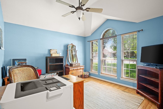 home office featuring ceiling fan, vaulted ceiling, and light hardwood / wood-style flooring