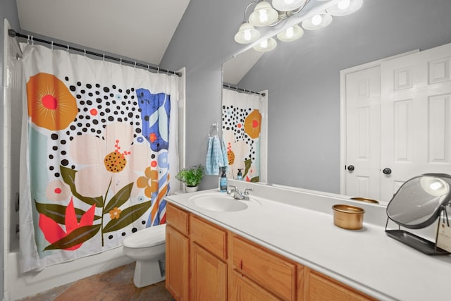 bathroom featuring lofted ceiling, tile patterned floors, vanity, and toilet