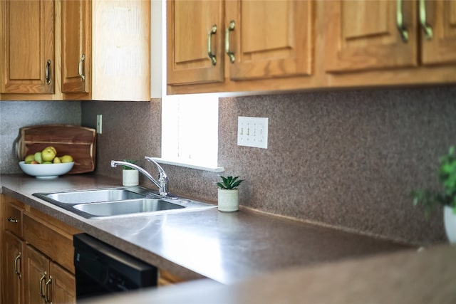 kitchen with sink, tasteful backsplash, and dishwasher