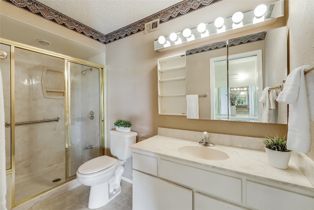 bathroom with tile patterned floors, a textured ceiling, vanity, toilet, and a shower with door