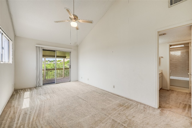 spare room featuring light colored carpet, high vaulted ceiling, and ceiling fan