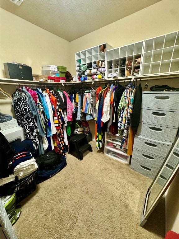 walk in closet featuring carpet floors