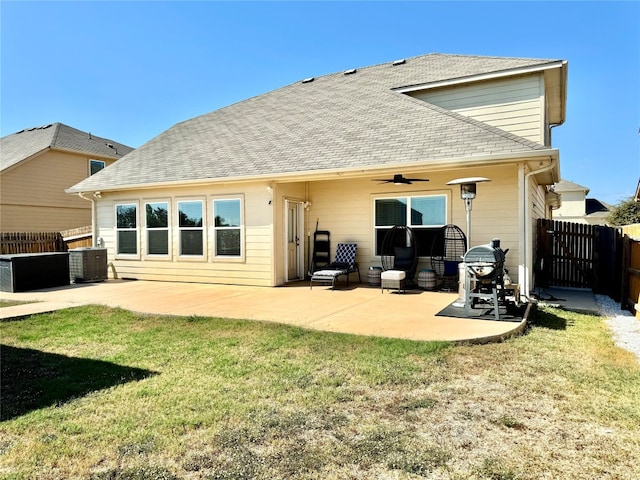 back of property with a yard, a patio area, and central AC unit