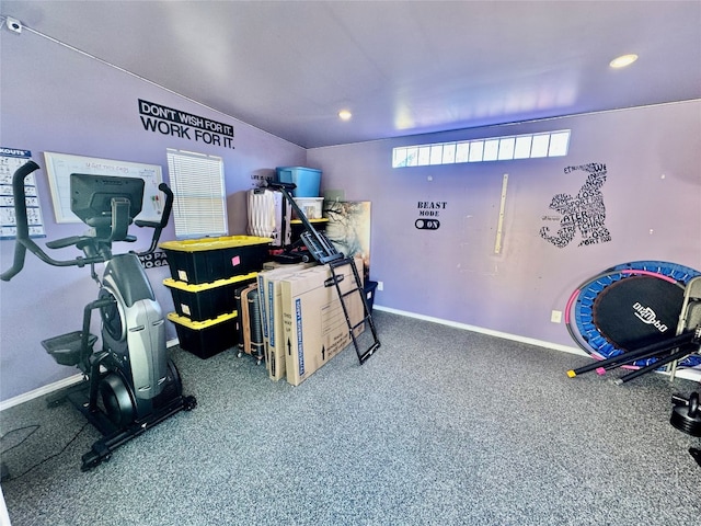 exercise room with vaulted ceiling