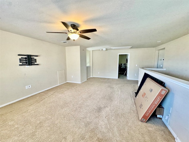 carpeted spare room with ceiling fan and a textured ceiling