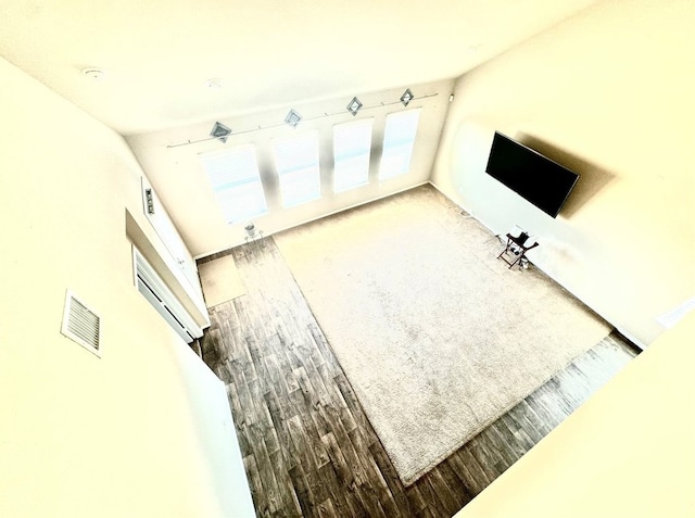 unfurnished living room with wood-type flooring