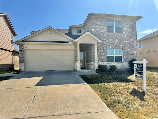 view of front facade featuring a front yard and a garage