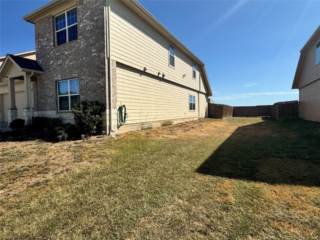 view of home's exterior with a lawn