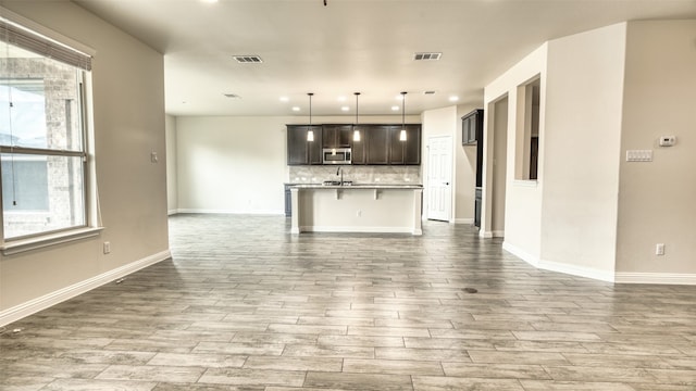 unfurnished living room featuring sink