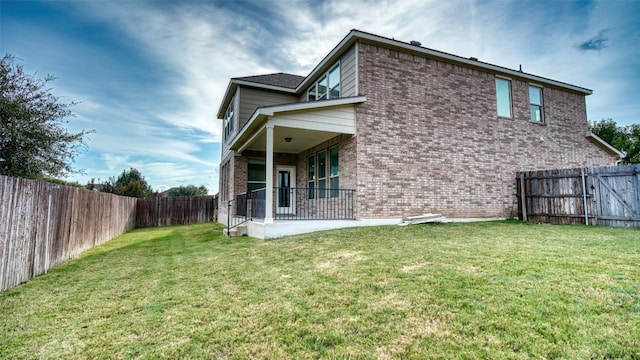 rear view of house with a yard