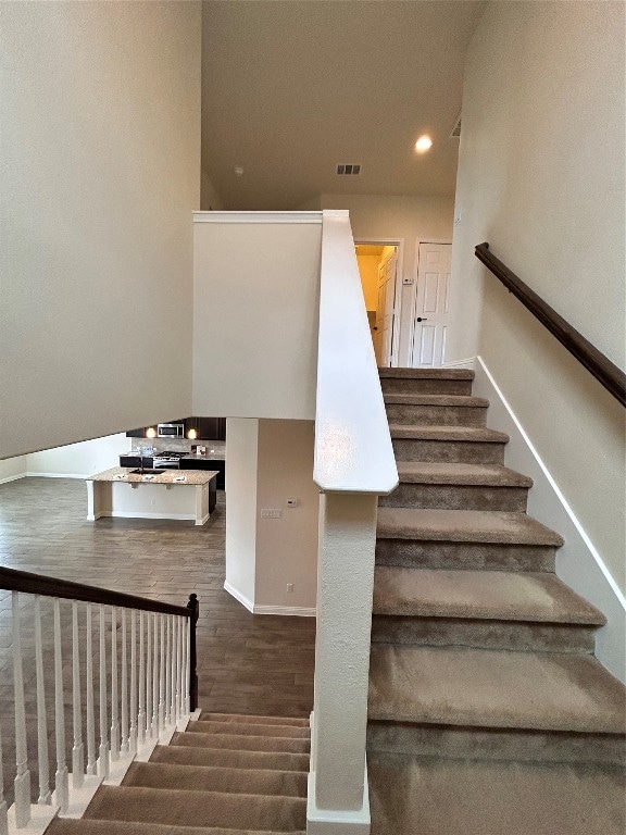 stairway with hardwood / wood-style floors