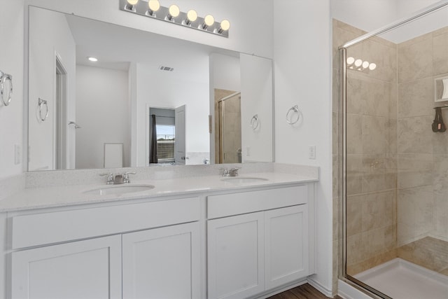 bathroom featuring vanity and an enclosed shower