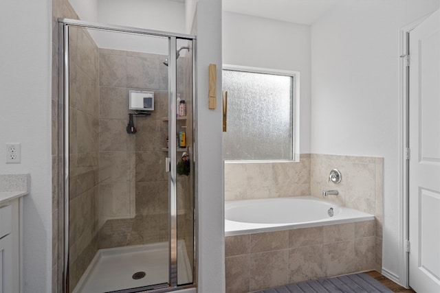 bathroom with plus walk in shower and vanity