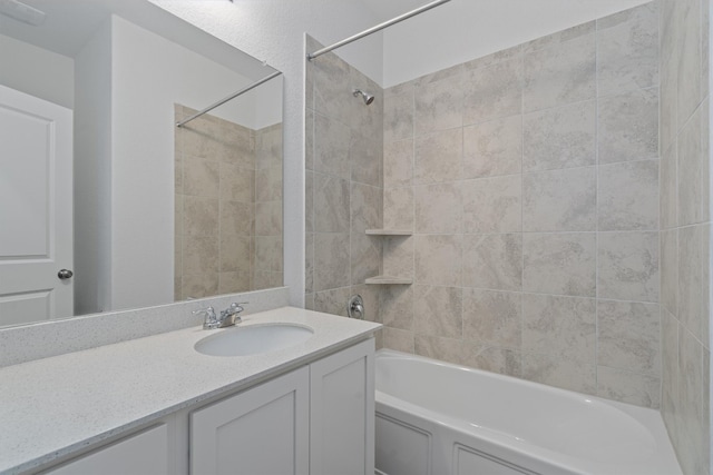 bathroom featuring vanity and tiled shower / bath