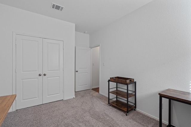 carpeted bedroom with a closet