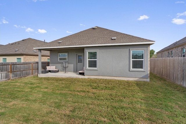 rear view of house with a lawn, an outdoor living space, and a patio