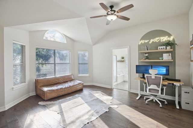 office space featuring built in shelves, ceiling fan, dark hardwood / wood-style flooring, and vaulted ceiling