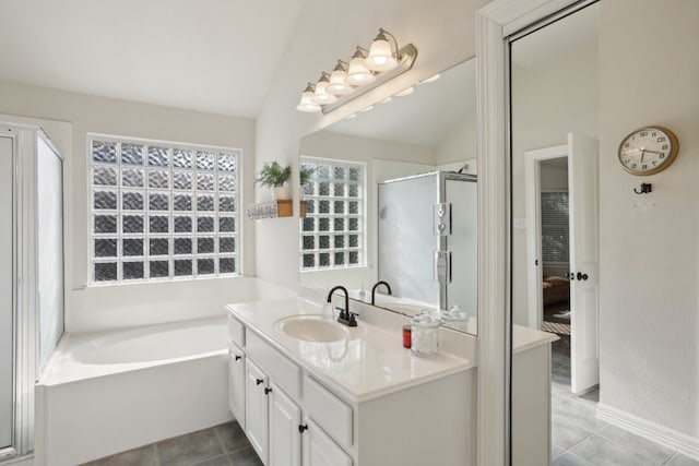 bathroom with plus walk in shower, vanity, vaulted ceiling, and tile patterned flooring