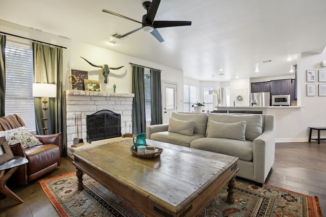 living room with ceiling fan, dark hardwood / wood-style flooring, and a fireplace