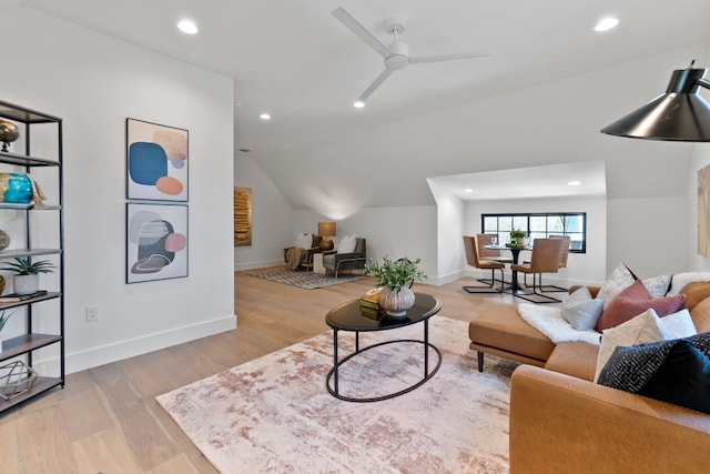 living room featuring light hardwood / wood-style floors, ceiling fan, and lofted ceiling