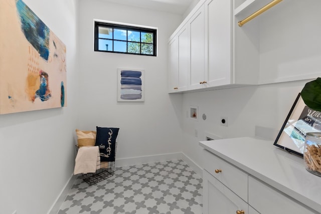 clothes washing area featuring light tile patterned floors, hookup for a washing machine, electric dryer hookup, and cabinets