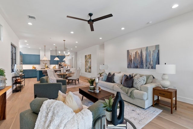 living room featuring ceiling fan and light wood-type flooring