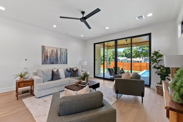 living room with ceiling fan and light hardwood / wood-style floors