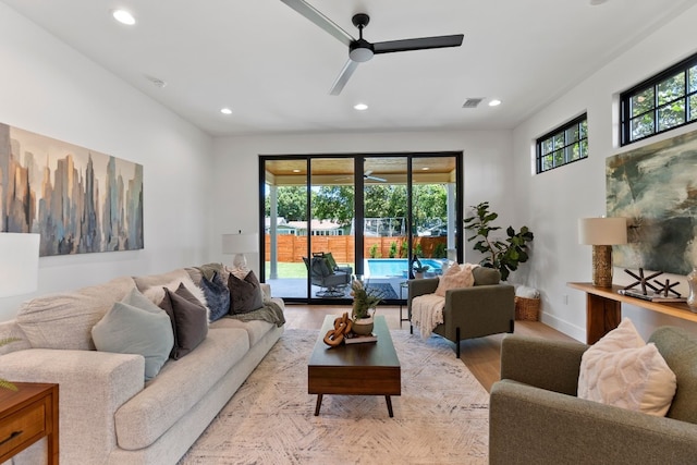 living room with light wood-type flooring and ceiling fan