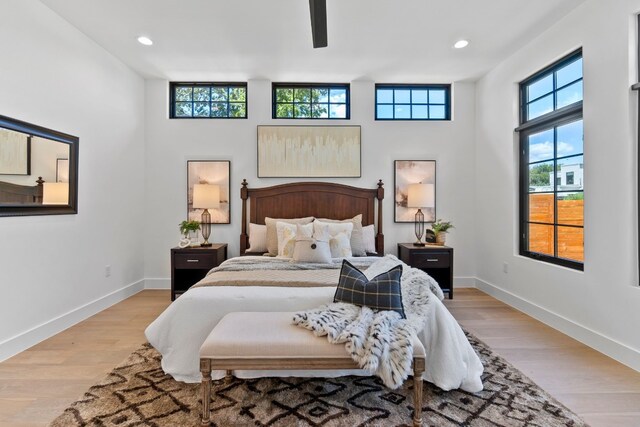 bedroom with ceiling fan and light hardwood / wood-style flooring