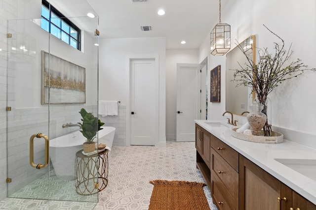 bathroom featuring tile patterned floors, double sink vanity, and a washtub