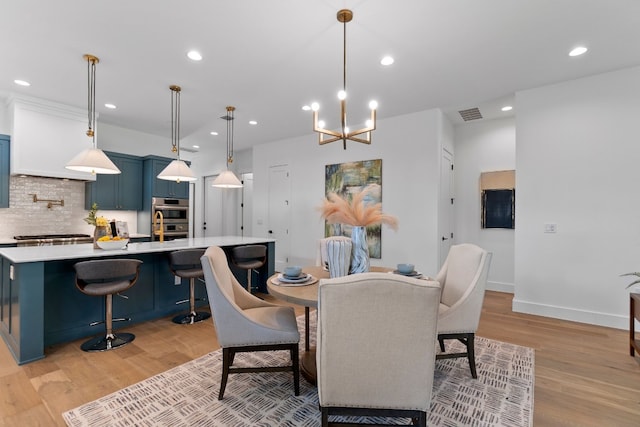 dining room with an inviting chandelier and light wood-type flooring