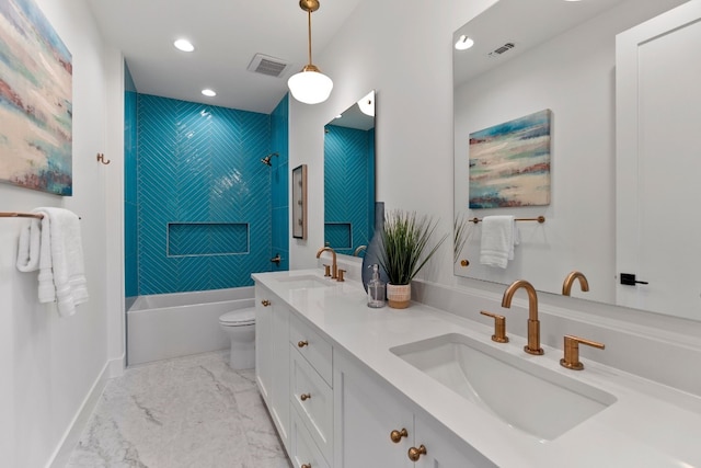 full bathroom featuring tile patterned floors, double sink vanity, tiled shower / bath, and toilet