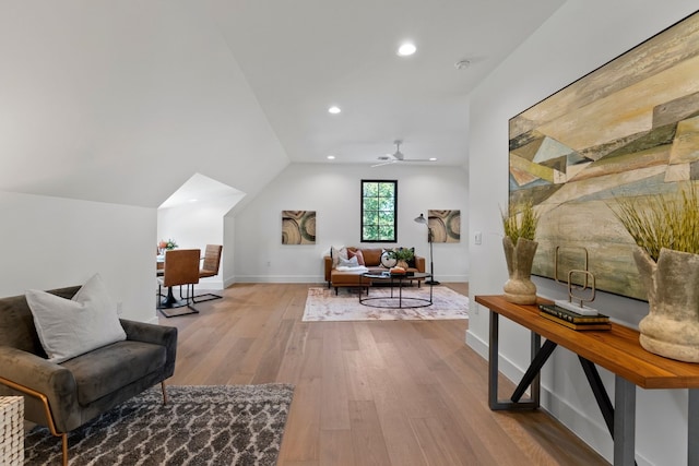 interior space with ceiling fan, vaulted ceiling, and light hardwood / wood-style flooring