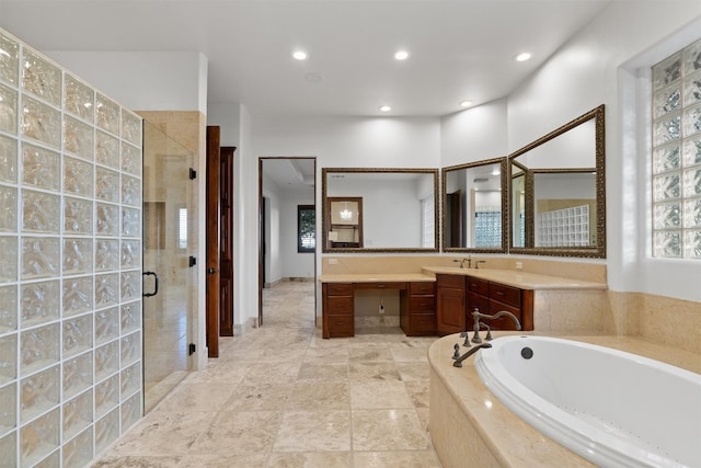 bathroom with vanity and shower with separate bathtub