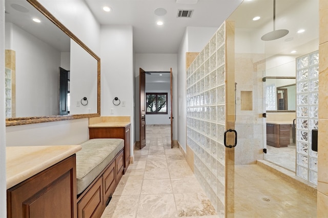 bathroom with walk in shower and vanity