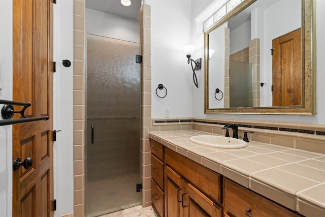 bathroom with vanity and a shower with door