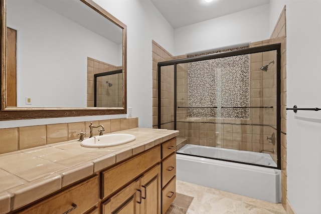 bathroom with vanity and shower / bath combination with glass door