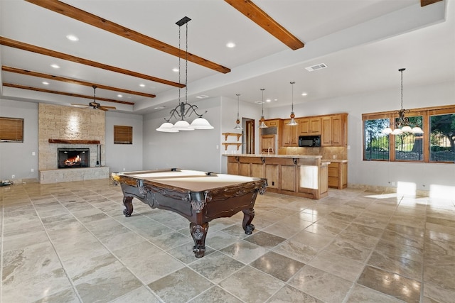 recreation room with beamed ceiling, ceiling fan, a fireplace, and billiards