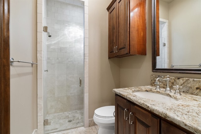 bathroom with vanity, an enclosed shower, and toilet