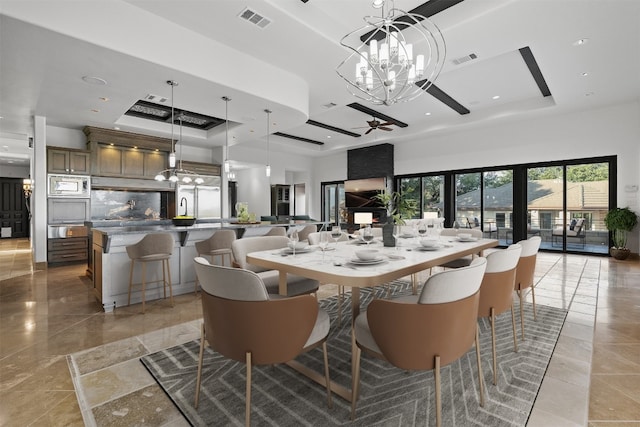 dining room featuring an inviting chandelier and a tray ceiling