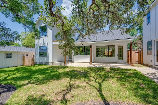 rear view of house with a lawn