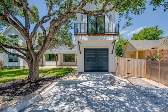 1928 Miles Ave Unit 2, Austin, TX 78745 - view of front of property featuring a balcony, an attached garage, driveway, and a gate