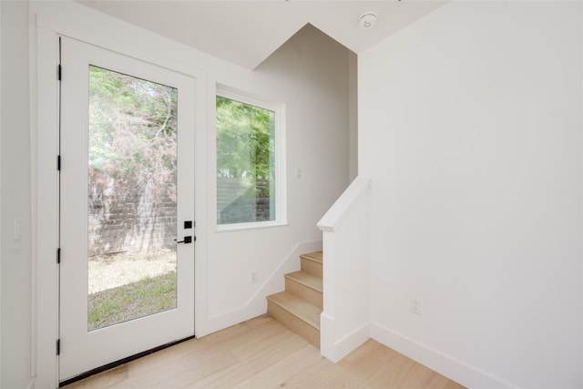 doorway featuring light wood-type flooring and a wealth of natural light