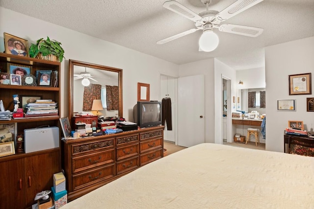 bedroom featuring a textured ceiling, connected bathroom, visible vents, and a ceiling fan