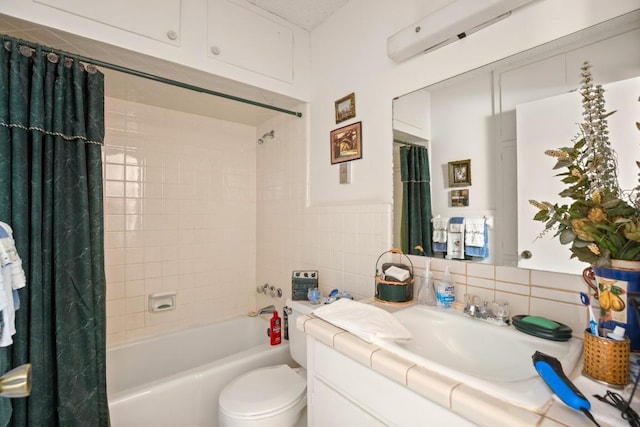 full bath featuring shower / bathtub combination with curtain, tile walls, toilet, and vanity