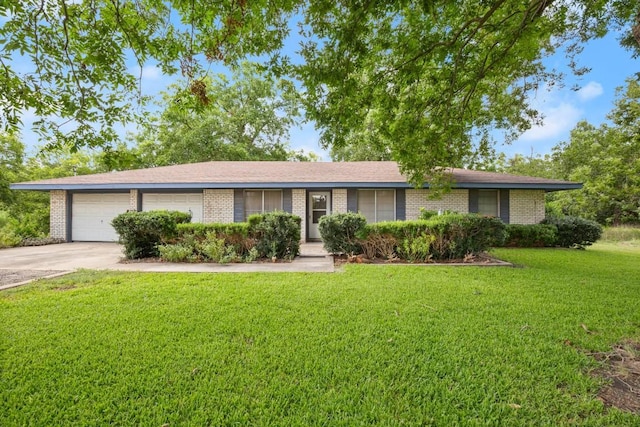 single story home featuring a garage, a front yard, concrete driveway, and brick siding