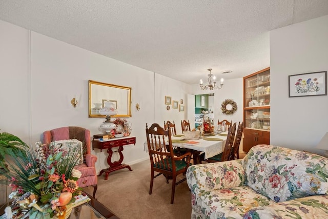 dining space with carpet floors, a chandelier, and a textured ceiling