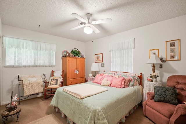 bedroom with light carpet, a textured ceiling, and a ceiling fan