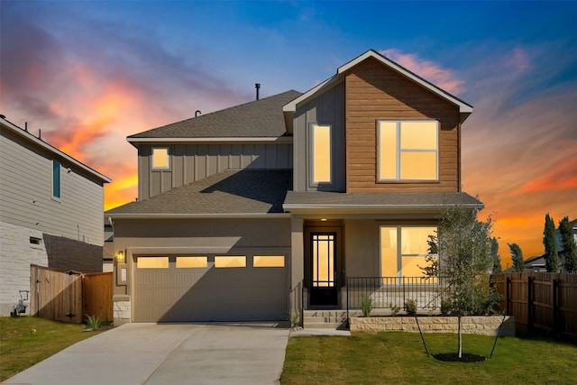 view of front of property featuring a garage and a yard